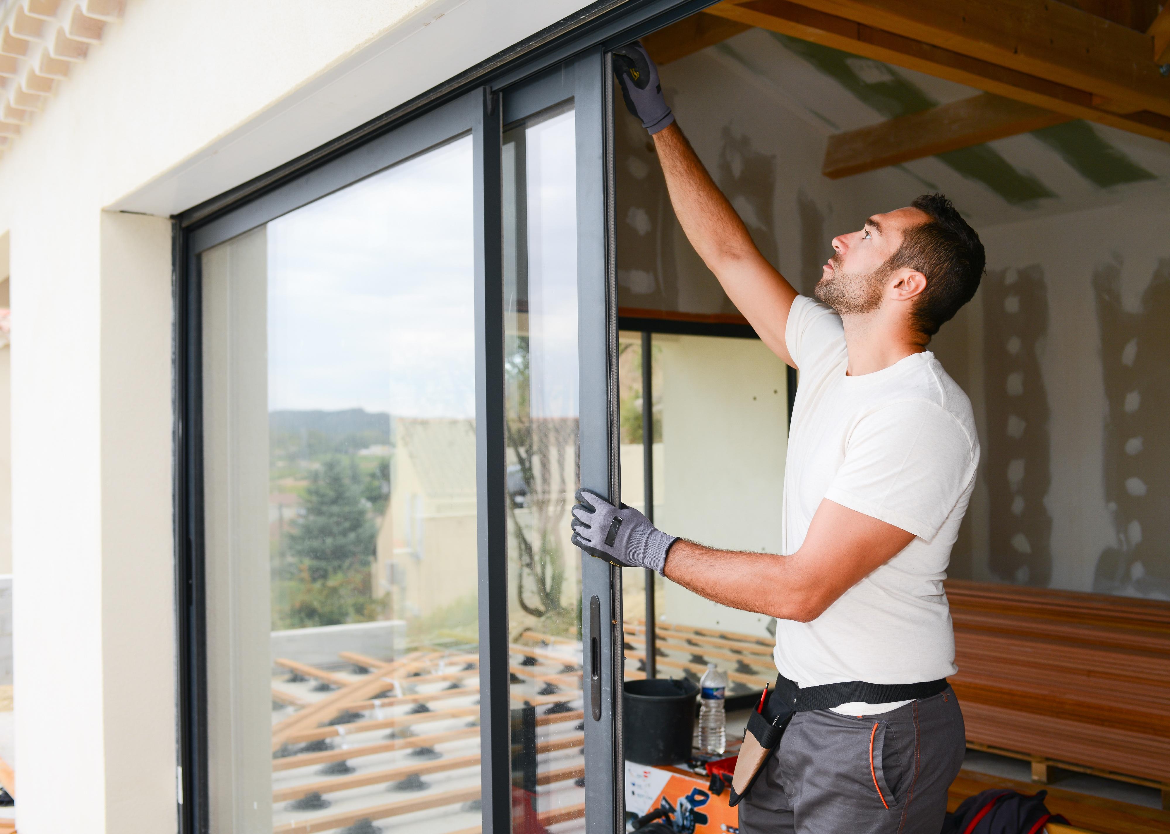Person installing bay window in a new house