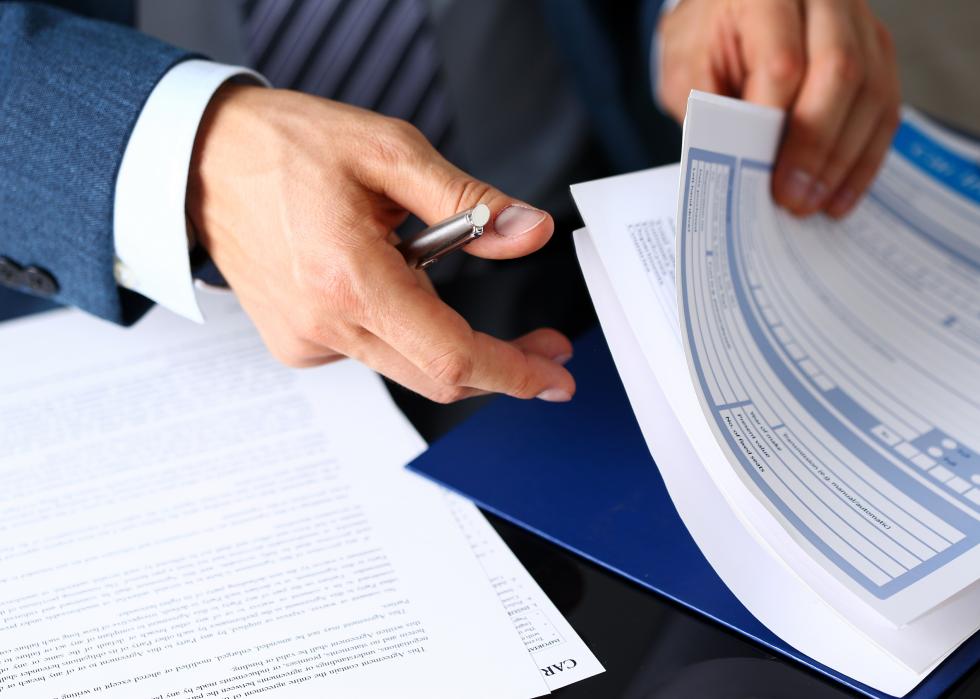 Male arm in suit with insurance form