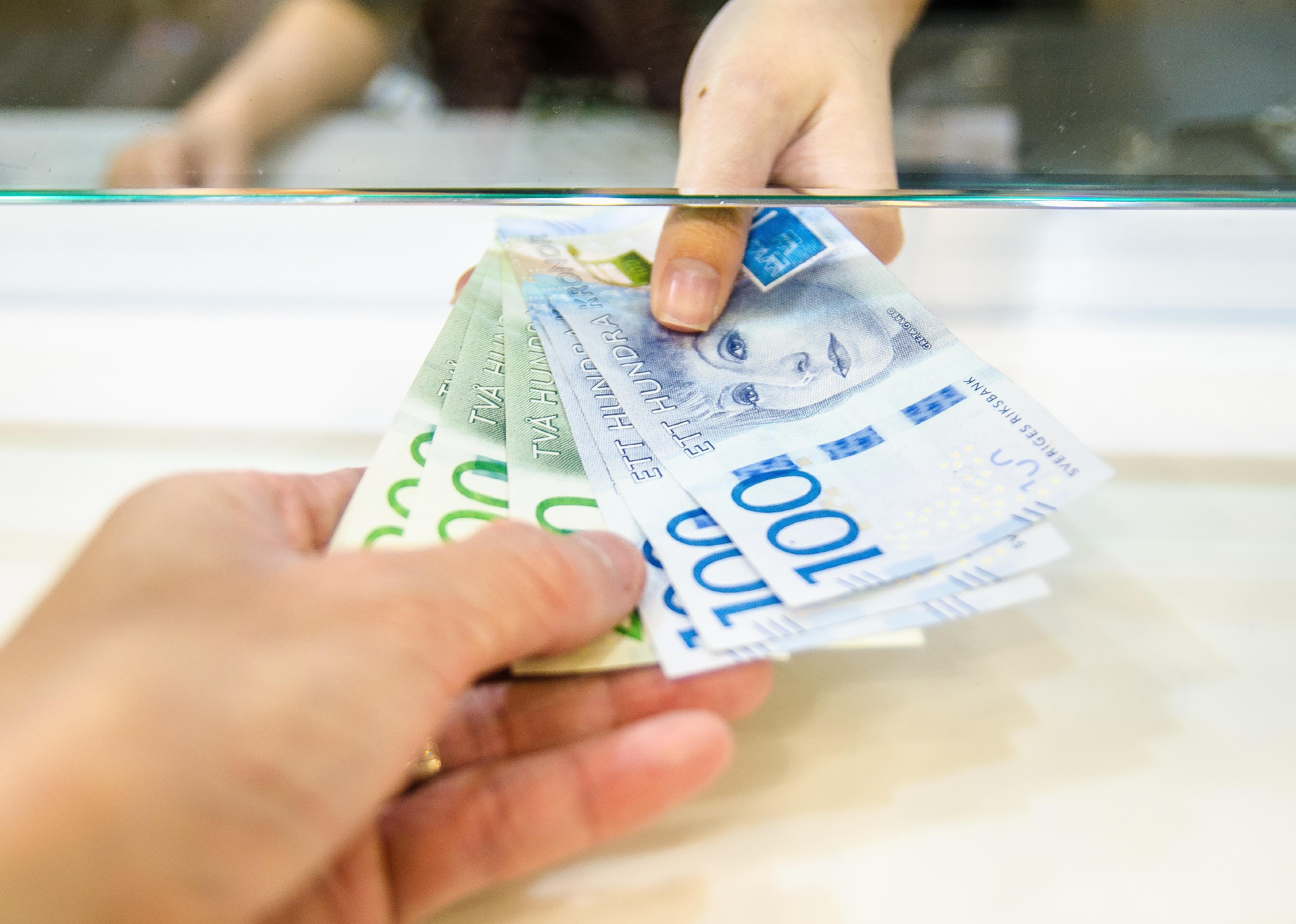 Close-up of two hands exchanging money