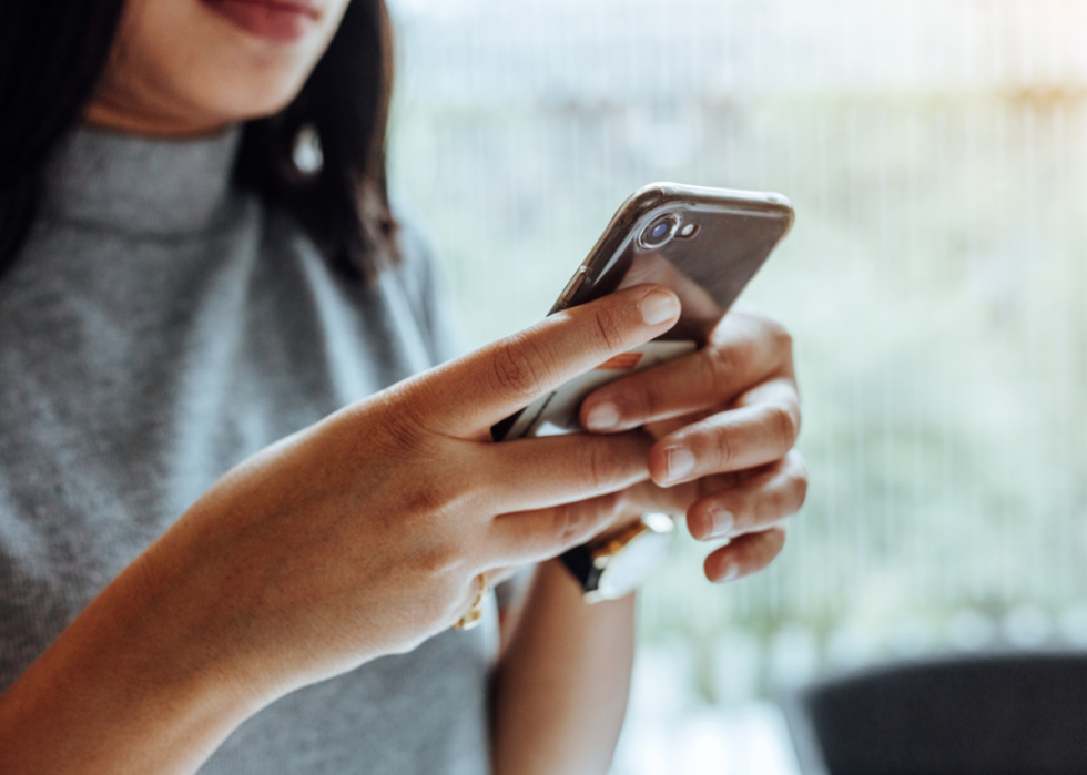 A woman looking at a cell phone.