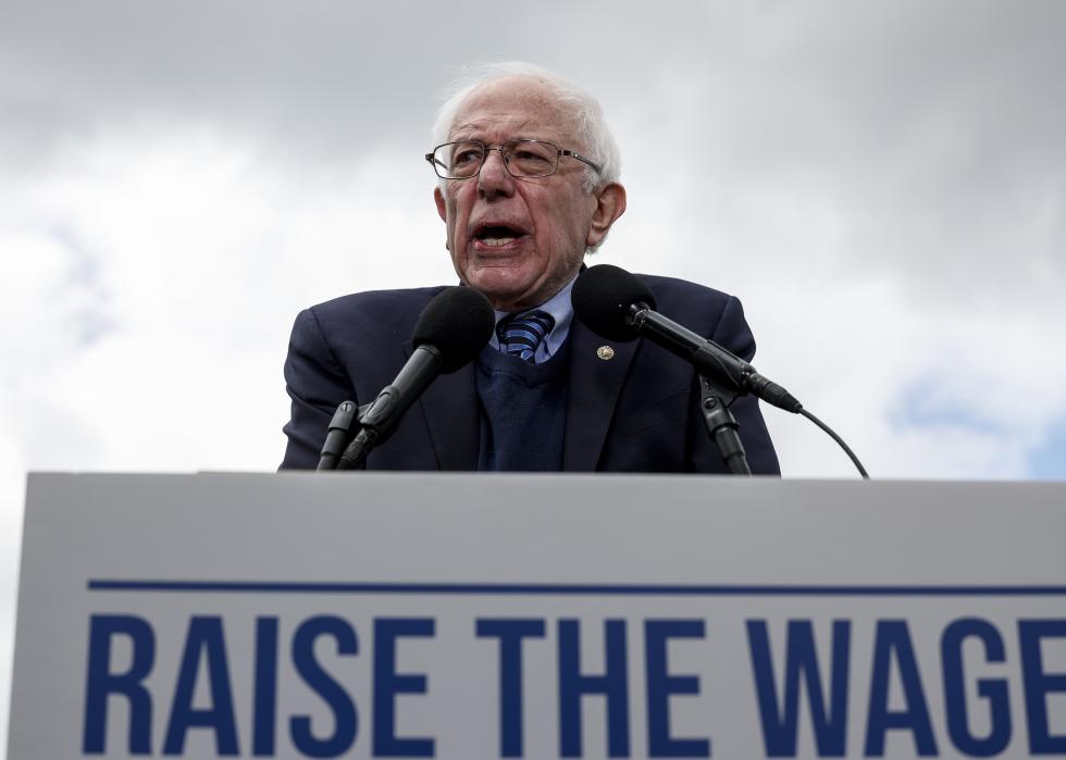 Bernie Sanders speaking at a podium about the minimum wage.