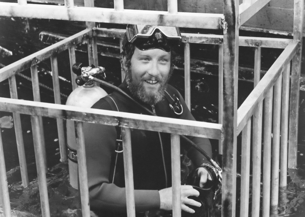 Richard Dreyfuss in a shark cage and scuba gear.