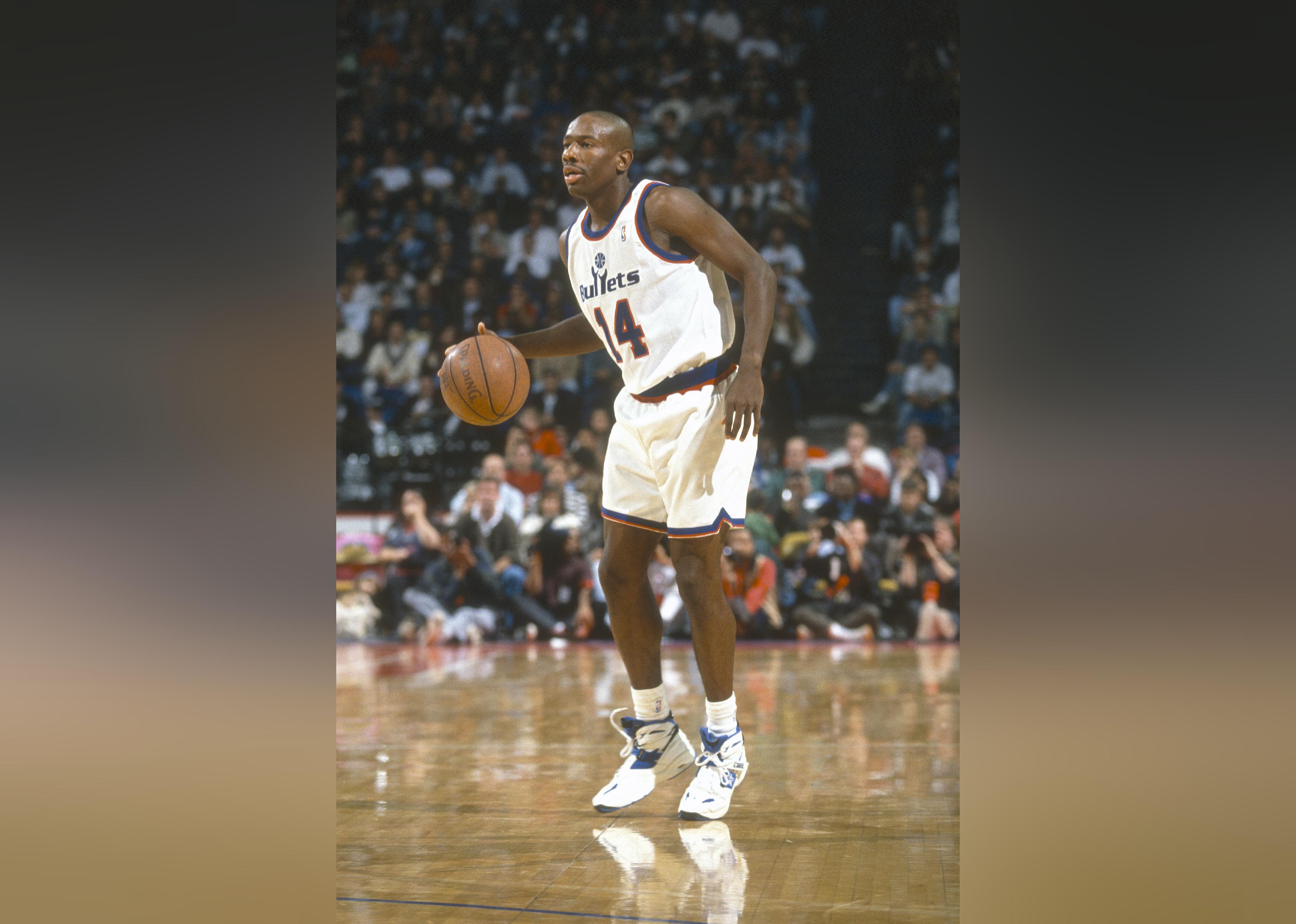 Doug Overton of the Washington Bullets dribbles the ball during a basketball game.
