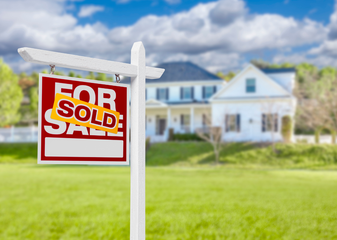 Beautiful new 2 story home with sold sign in yard.