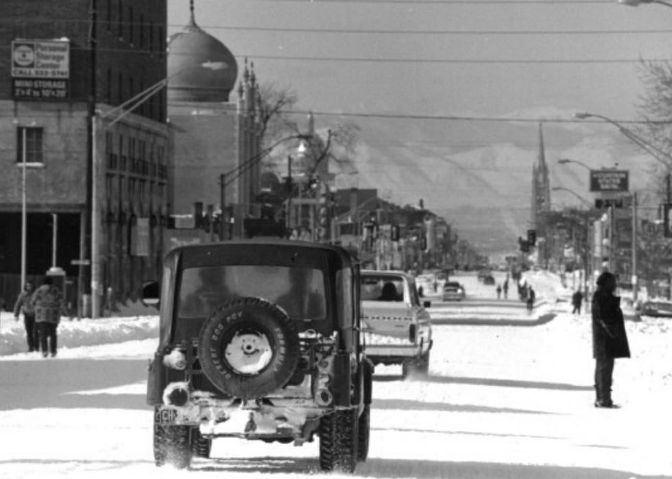 Snowy street scene with traffic.