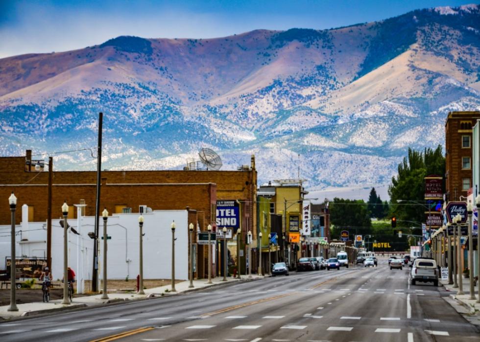A quiet downtown street with mountains in the background.