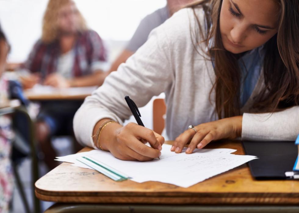 A young woman working in a class.