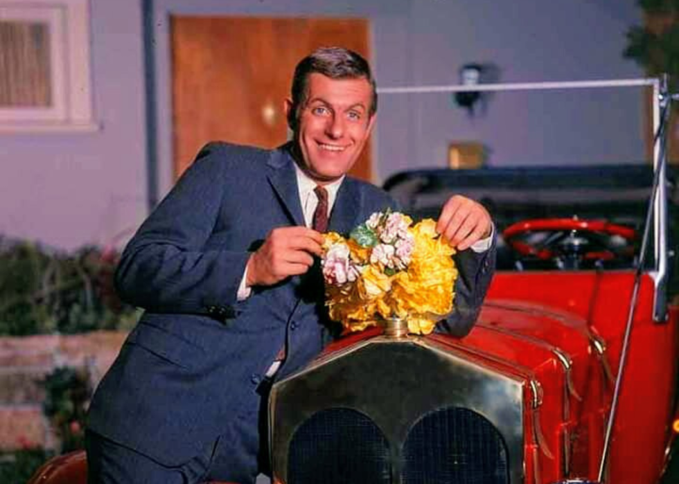 Jerry Van Dyke with a red antique car.