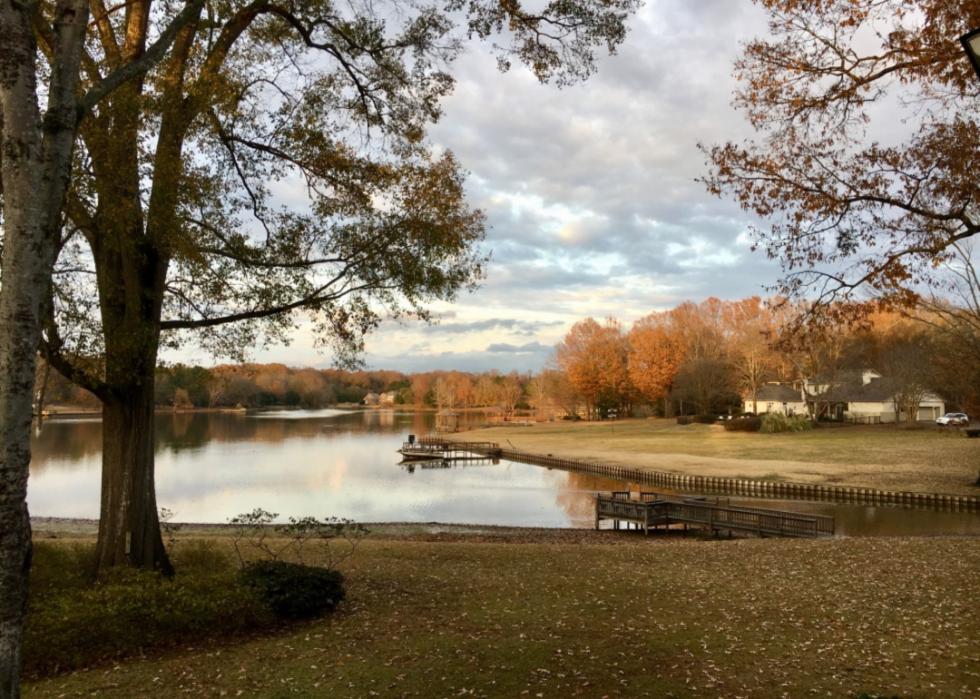 A beautiful home by a lake in Fall.