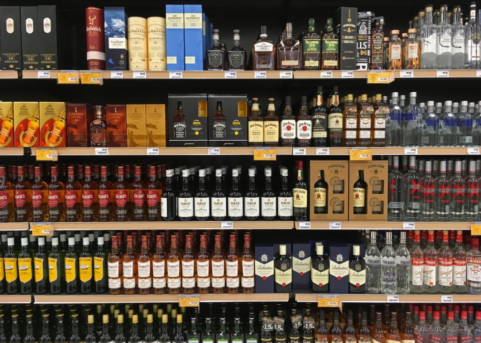 Whisky and vodka bottles on display at a liquor store