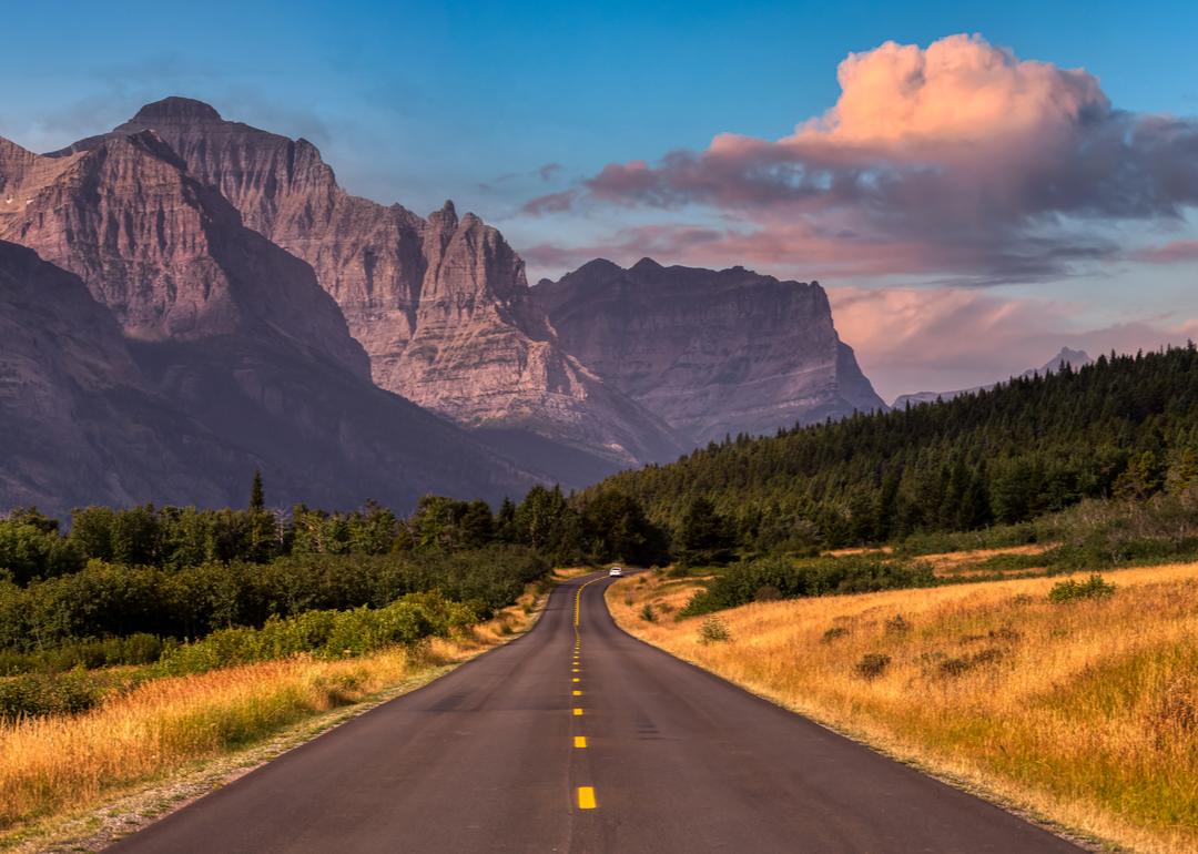 A scenic highway in St. Mary, Montana, with the Rocky Mountains in the background. 