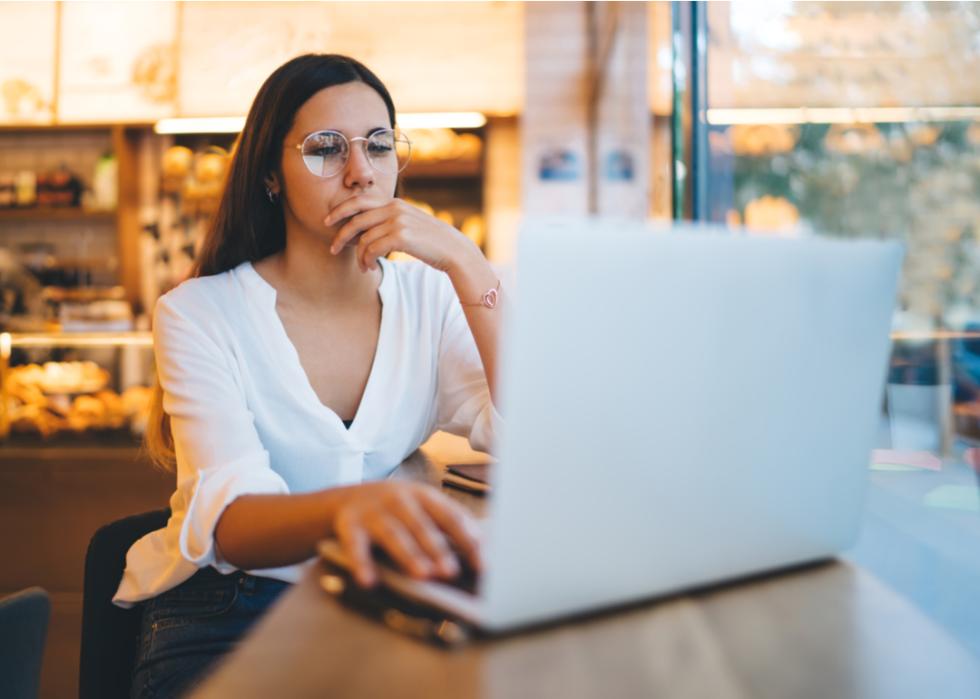A woman taking an online college course in a coffee shop