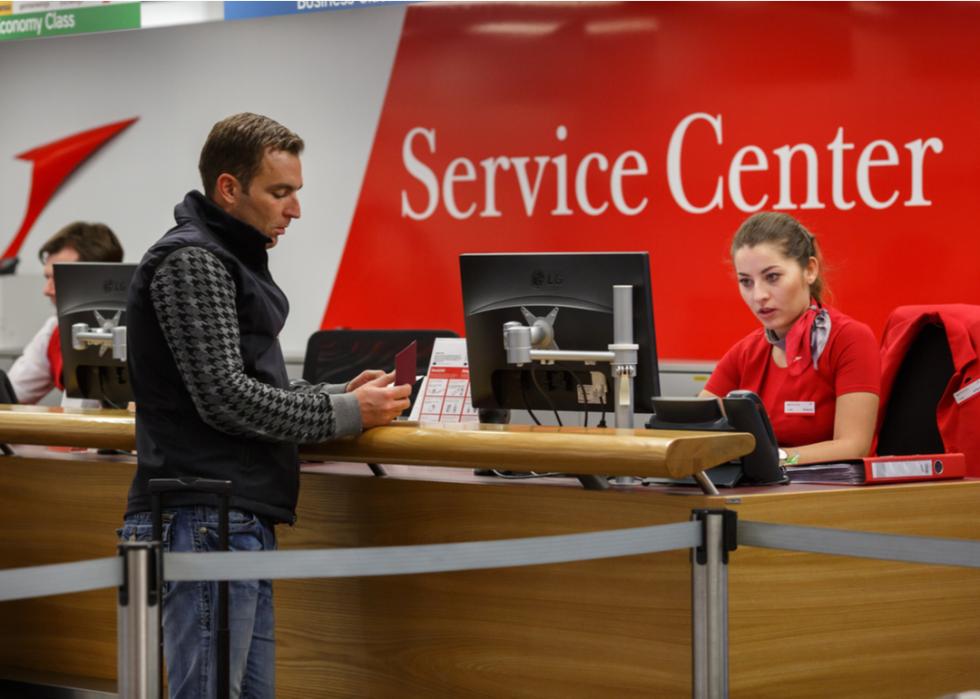 Customer working with an airport's service desk to secure seating