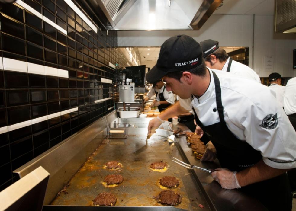 Cooks grilling burgers at Steak 'n Shake.