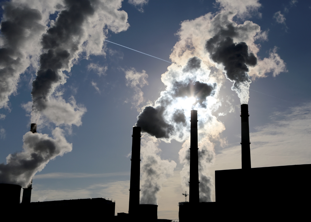 Emissions from smokestacks hide the sun. 