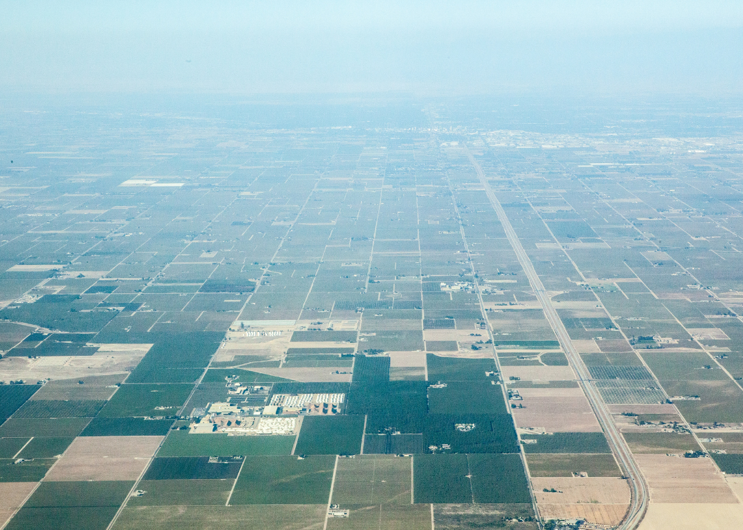A view of smog-filled skies over farm land.