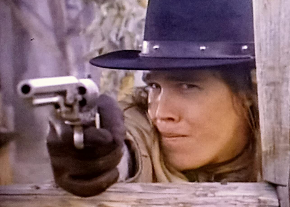 A cowboy shooting a gun.