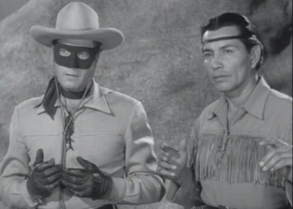 A cowboy in a mask and a Native American.