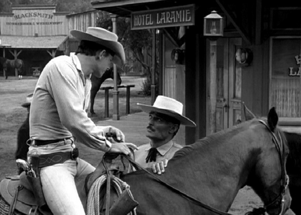 A man on horseback talking to another man.