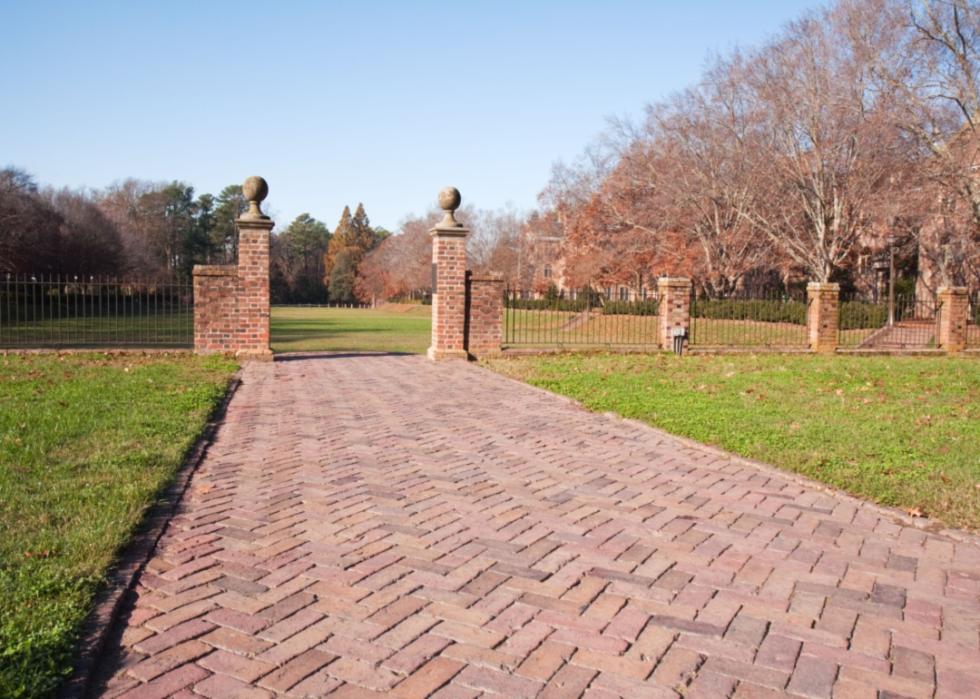 A brick walkway to a garden at William & Mary.