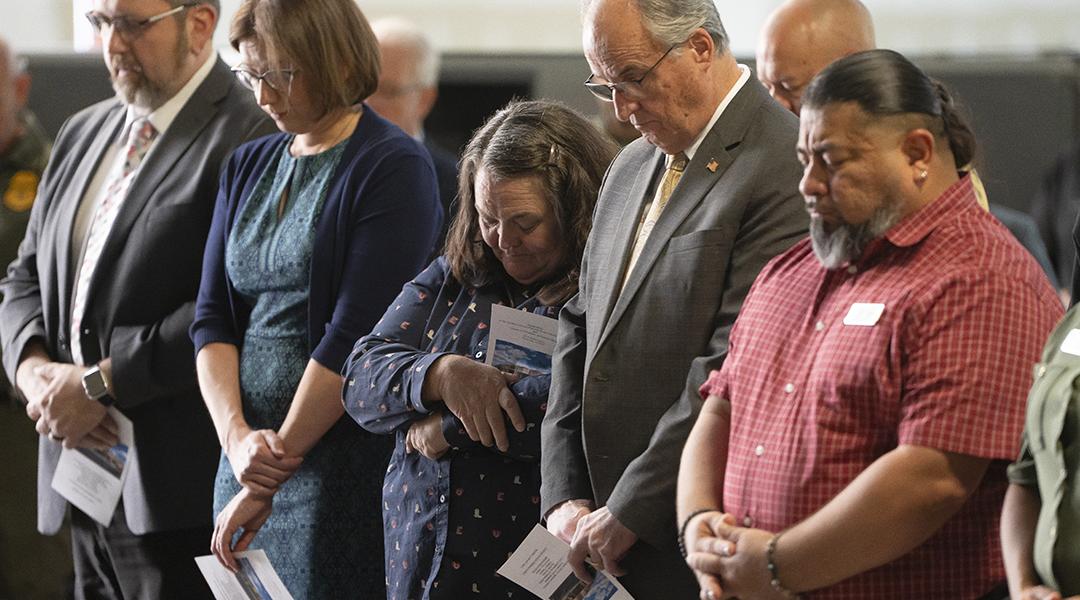 Cochise County Supervisor Peggy Judd, center, bows her head in prayer during the inauguration of the Southern Arizona Regional Border Operations Center in Sierra Vista, Arizona.