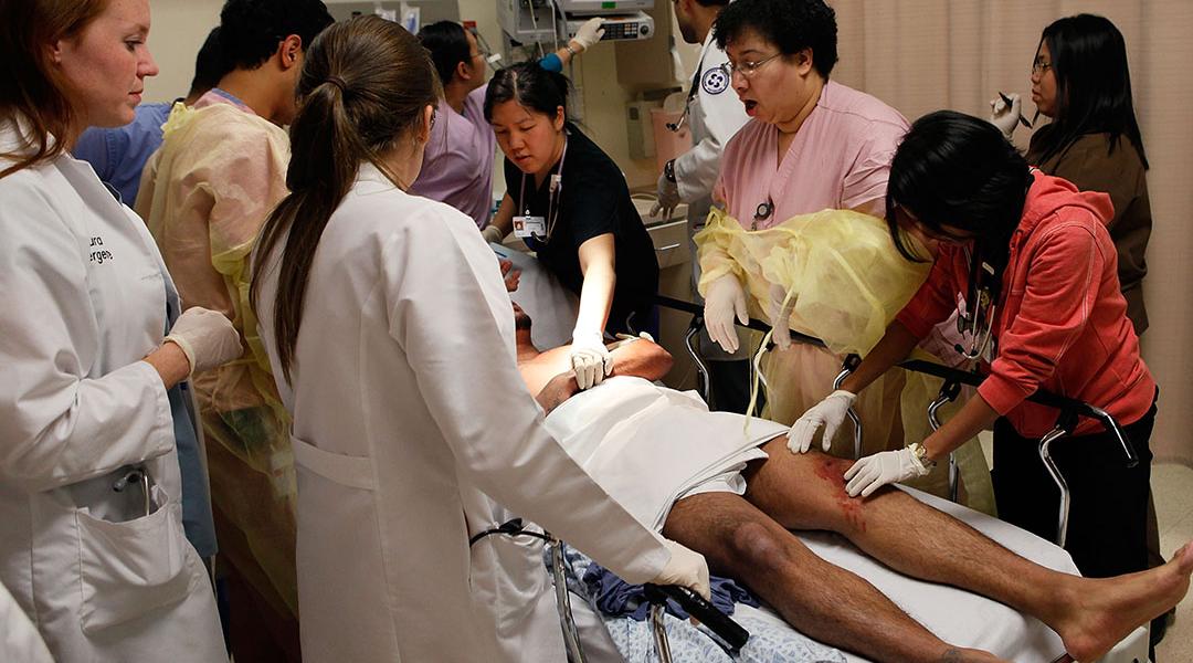 Staff in the Trauma Unit at the John H. Stroger Jr. Cook County Hospital treat a man with a gunshot wound.