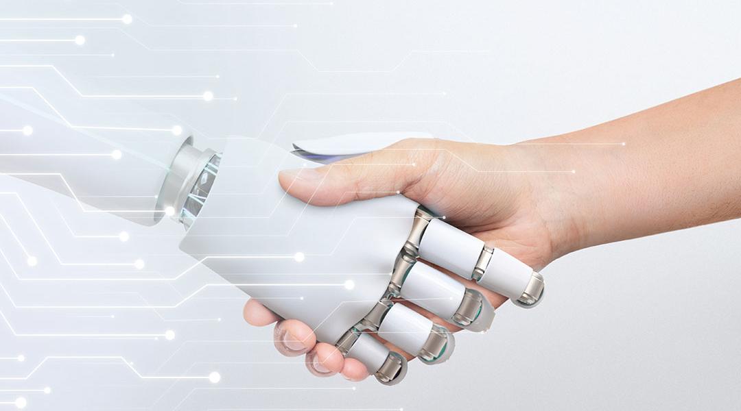 Human hand shaking robot hand, symbolizing human-robot collaboration and technology.