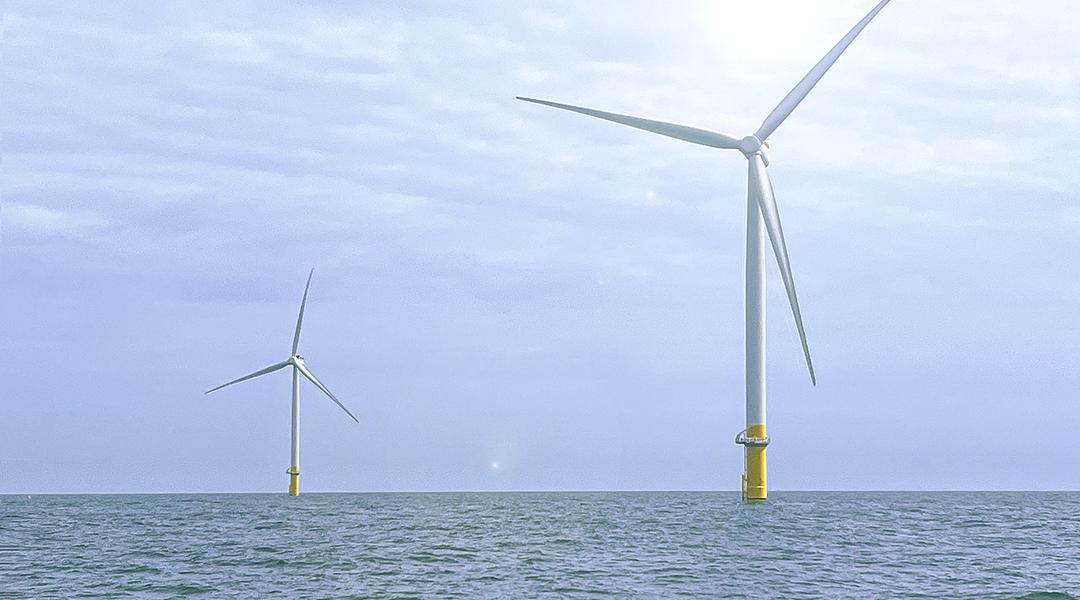 Two wind turbines in the ocean.