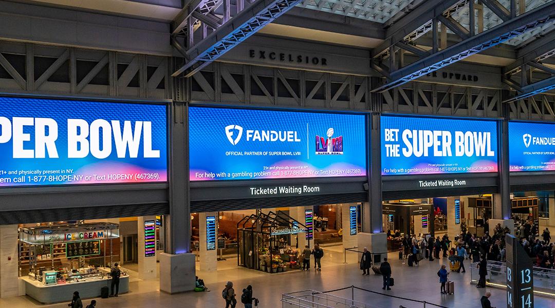 Ads for FanDuel, an online sports gambling copany, displayed on huge screens in the Moynihan Train Hall of Pennsylvania Station prior to the Super Bowl.