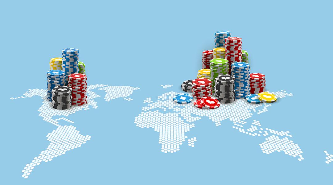 Colored casino chips on an illustration of the world map.