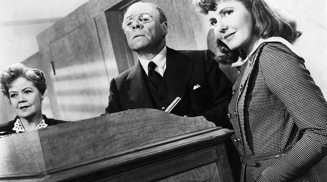 Black and white image of Spring Byington, unidentified man, and Jean Arthur in a scene from the film 'The Devil And Miss Jones', 1941.
