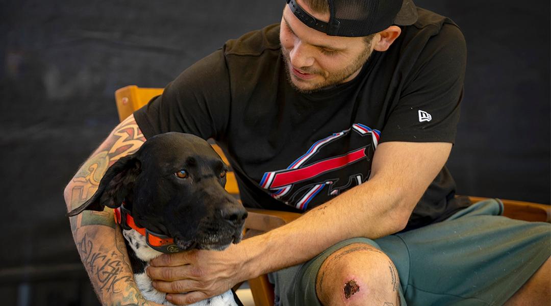 Jacob Schmitt with his dog Buddy, at his home in Ogden, on Thursday, July 31, 2025.