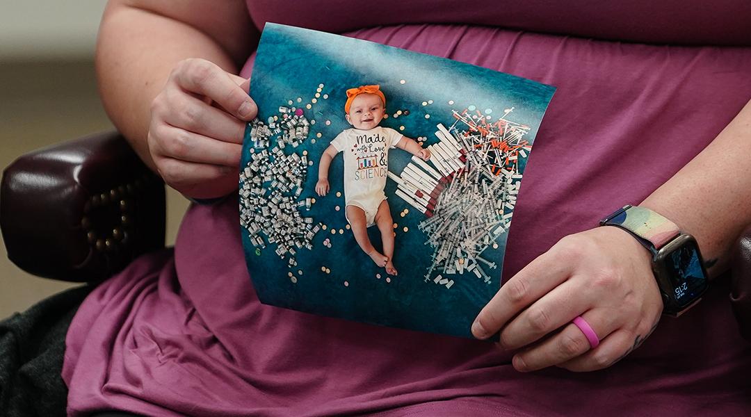 Elizabeth Goldman, an in-vitro fertilization patient at the University of Alabama at Birmingham, holds up a photo of her daughter who was born via the procedure.
