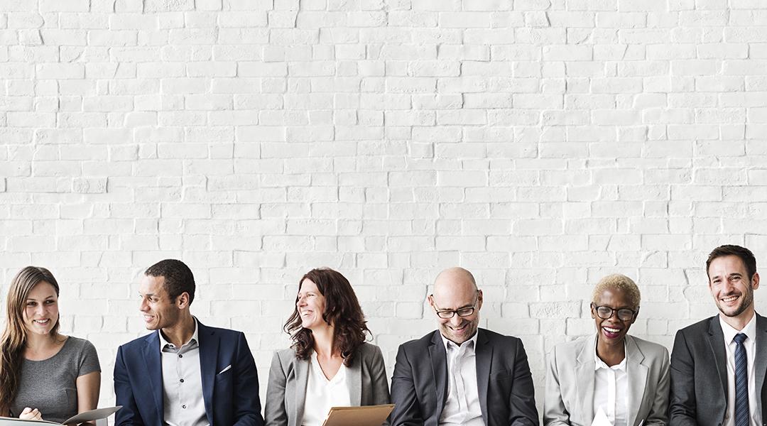 Professionals lined up sitting for a job interview.