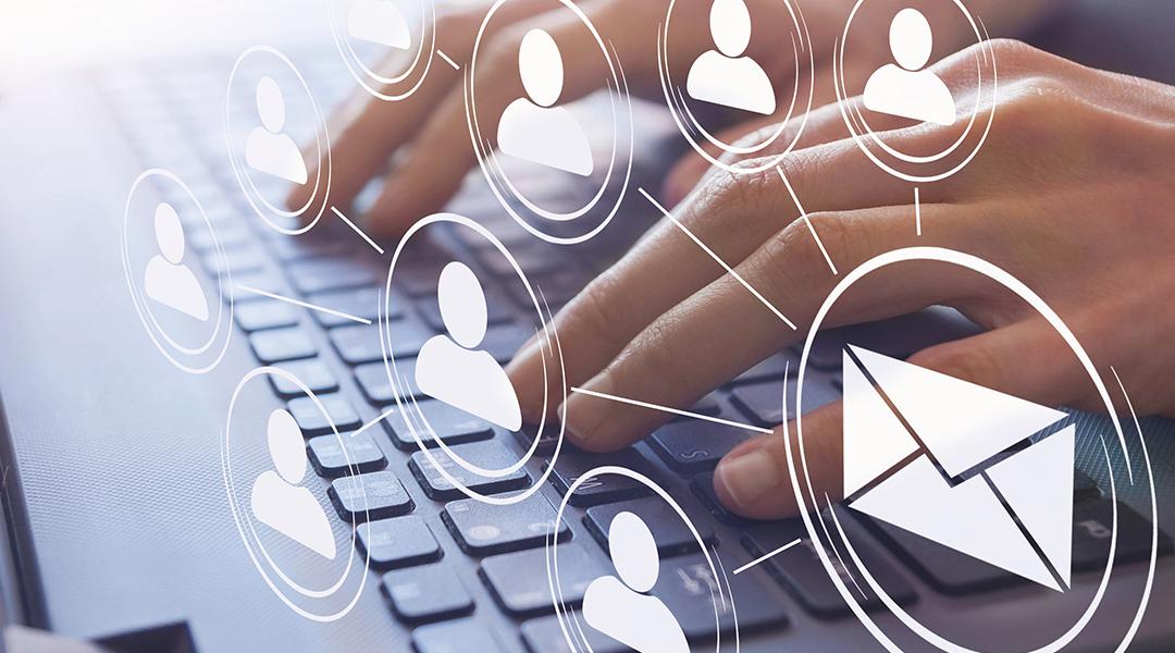 Hands typing on a keyboard illustrated with email and figure icons.