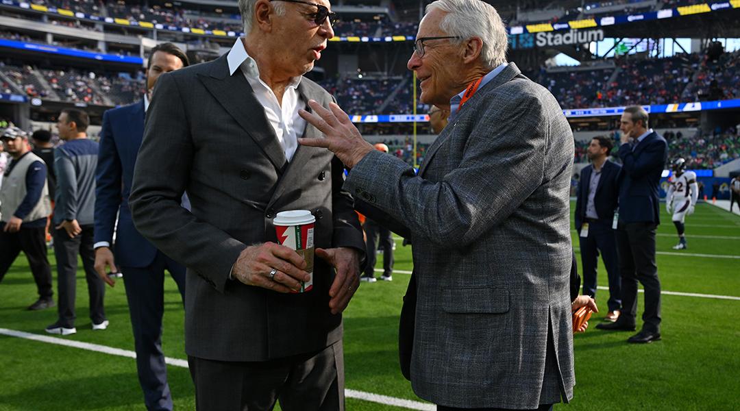 Stan Kroenke, owner of the Los Angeles Rams, talks with Rob Walton, owner of the Denver Broncos before a game at SoFi Stadium in Inglewood, California.