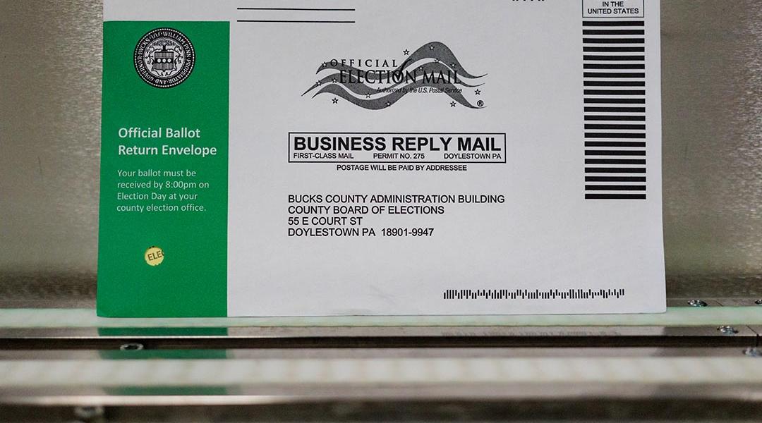 A Pennsylvania mail-in ballot with a green stripe on the envelope is displayed during a processing demonstration at the Board of Elections office on September 30, 2024 in Doylestown, Pennsylvania. 