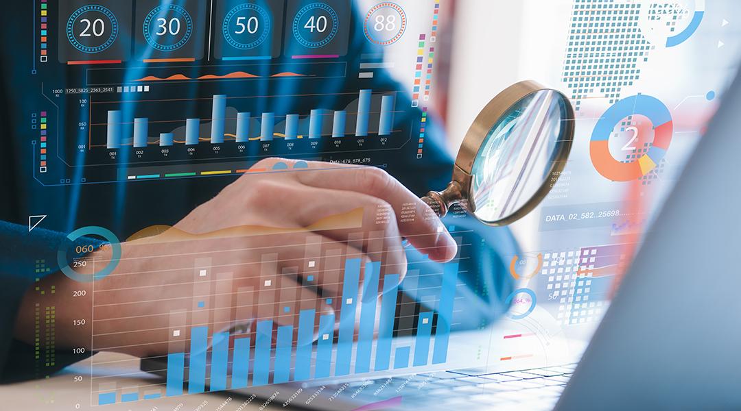 Person holding a magnifying glass close to a laptop screen, illustrated with data charts and graphics.