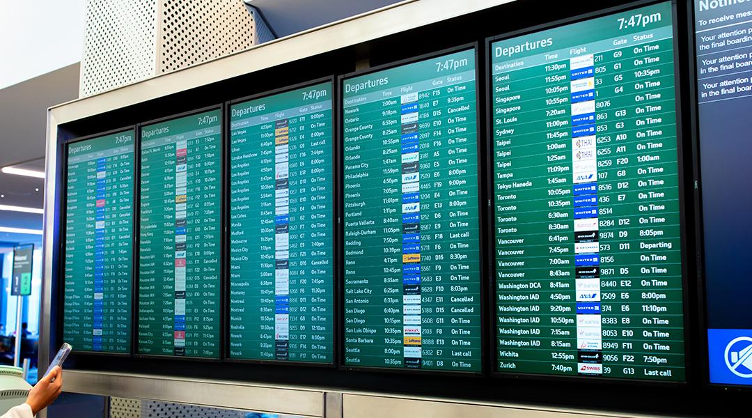 A flight arrival and departure board at an airport.